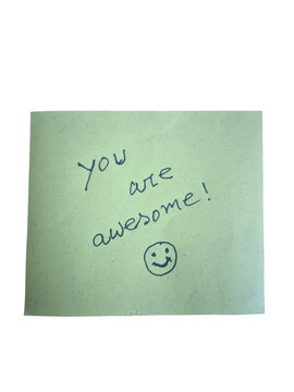 Green sticky note with you are awesome handwritten text