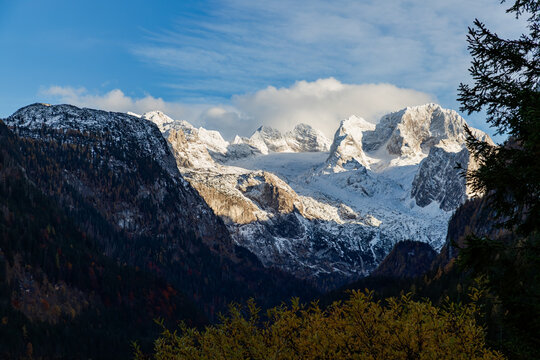 The colourful autumn scene of Austrian Alps with a view of the Dachstein mountain range covered by snow. Located in the Gosau Valley in Upper Austria. 