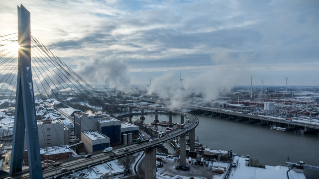 Aerial view of K&ouml;hlbrandbr&uuml;cke bridge in Hamburg port covered in winter snow.
