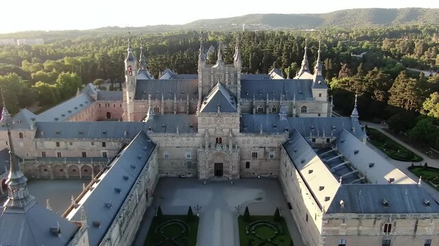 Aerial view of the Monastery of San Lorenzo de El Escorial during golden hour.