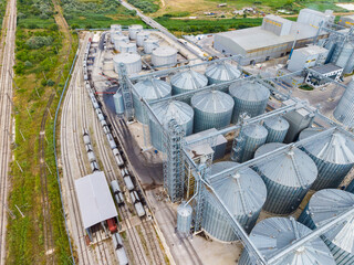 Grain storage facility located in a rural area with train tracks and silos near fields © DSMT