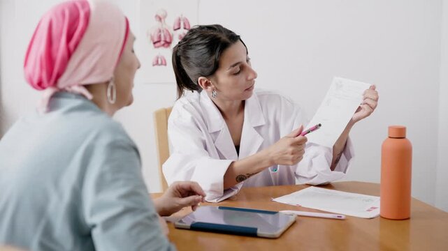 Young hispanic doctor prescribing medicine to cancer patient