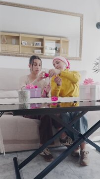 Mother with cancer and daughter preparing gifts together at home