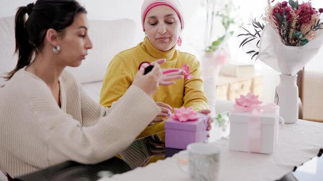 Daughter supporting mother with cancer preparing gifts