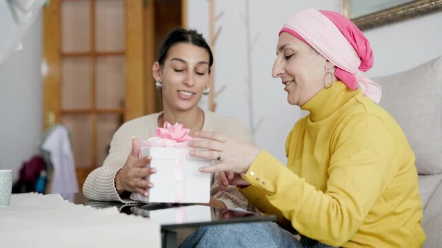 Daughter giving a gift to her mother with cancer