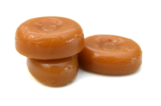 Caramel candies isolated on white background