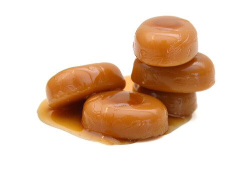 Caramel candies isolated on white background