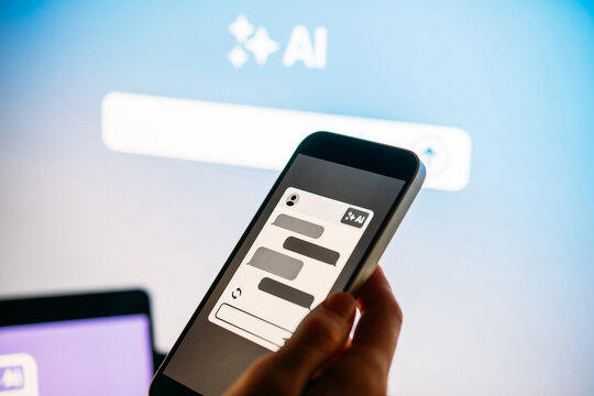 Young woman writing AI promt in a modern office.