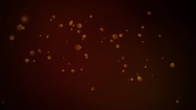 Abstract golden fire embers and sparks floating on a dark background