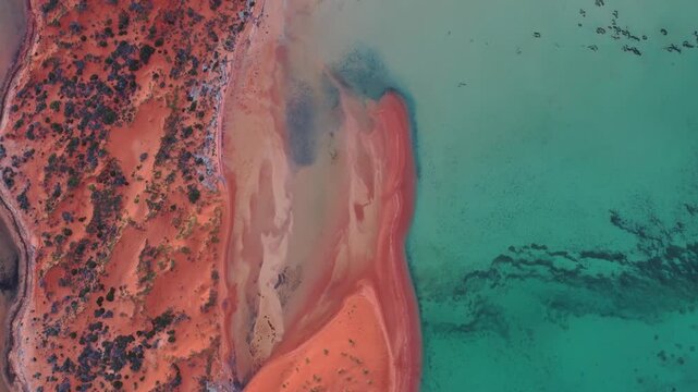 4K Aerial View of Contrasting Red Sand Dunes and Turquoise Waters of Shark Bay