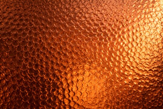 Copper textured surface with hammered pattern closeup