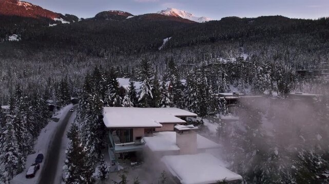Alpine homes on hill at sunset, Whistler Mountain, aerial footage, winter scene, log cabin, luxury vacation home, mountain home. 4K 24FPS PRORES