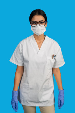 Healthcare professional wearing medical mask and gloves presenting protection