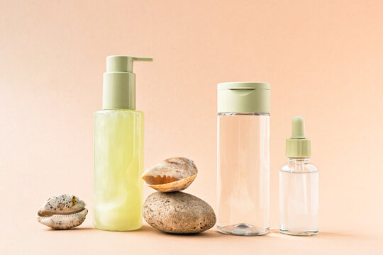 Minimalist natural cosmetic products arranged with seashells and pumice stone. Representing organic beauty, wellness, self-care