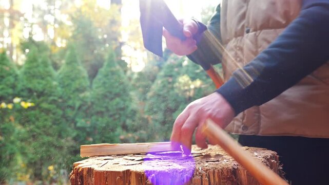 Stockpiling Firewood for the Heating Season. process of chopping firewood.Man Splitting Wood with Axe Outdoors. 4k footage
