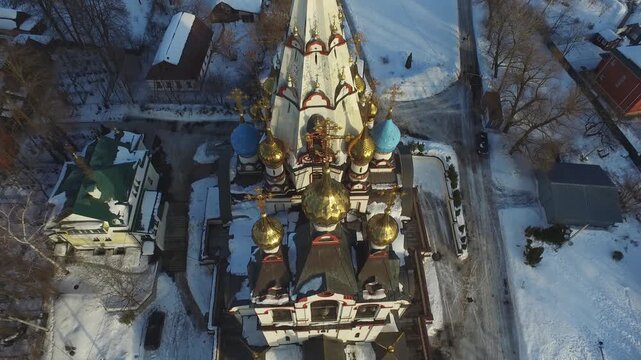 Drone lowering facing snowy church