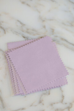 pile of individually wrapped purple jewelry polishing cloths