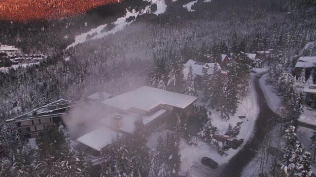 Alpine homes on hill at sunset, Whistler Mountain, aerial footage, winter scene, log cabin, luxury vacation home, mountain home. 4K 24FPS