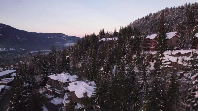 Alpine homes on hill at sunset, Whistler Mountain, aerial footage, winter scene, log cabin, luxury vacation home, mountain home. 4K 24FPS