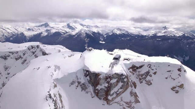 Aerial drone view of Whistler ski resort alpine terrain and snow-covered mountain peaks, British Columbia