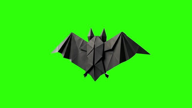 Detailed 3D model of a black paper origami bat with spread wings, isolated on a bright green screen chroma key background. Perfect for Halloween video compositing, papercraft DIY promos, spooky animat