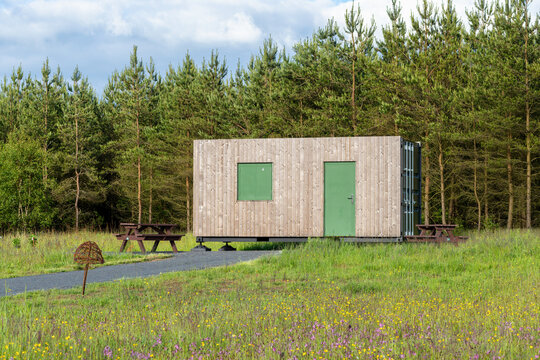 Converted shipping container food kiosk with timber cladding in woodland park