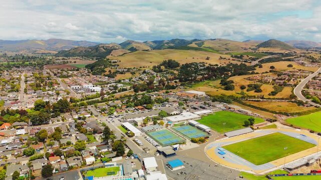 Drone ascends above a suburban sports complex in Arroyo Grande revealing surrounding area
