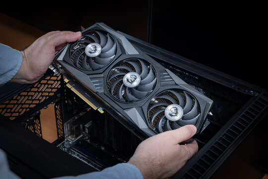 Assembly or upgrade of an expensive gaming PC or graphics workstation. Technician holding an expensive powerful MSI graphics card. Pavlodar, Kazakhstan - June 08, 2024