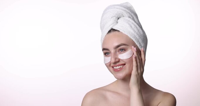 Beautiful woman with eye patches on white background