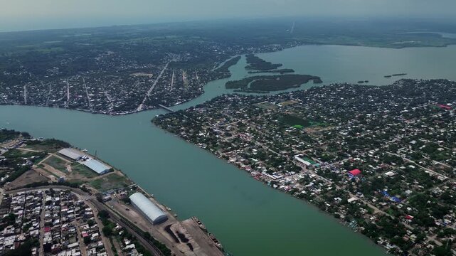 Aerial drone footage of Panuco river at Tampico port showing junction with Pueblo Viejo lagoon and state boundary between Tamaulipas Veracruz