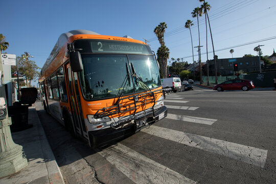 Los Angeles, California, USA - June 18, 2026: An Orange Metro Bus stops on Sunset Boulevard.