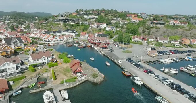 Aerial view of coastal marina and residential area in H&oslash;llen Norway in slow motion