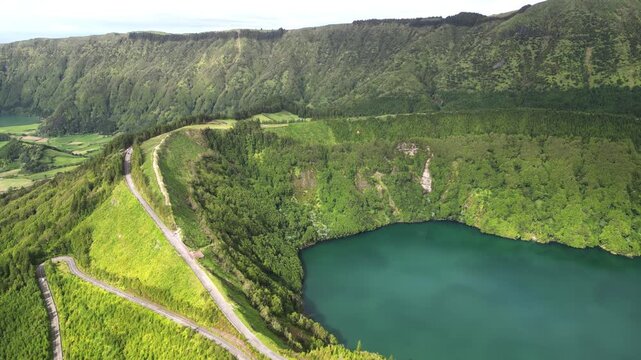 Aerial View, Lagoa de Santiago within the Sete Cidades volcanic caldera on S&atilde;o Miguel Island, Azores, Portugal, surrounded by forest, steep crater slopes and natural landscape