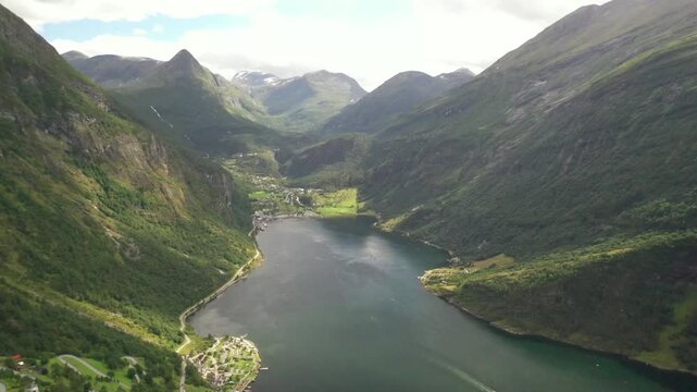 Aerial view of Geiranger fjord winding between steep green mountains in Norway