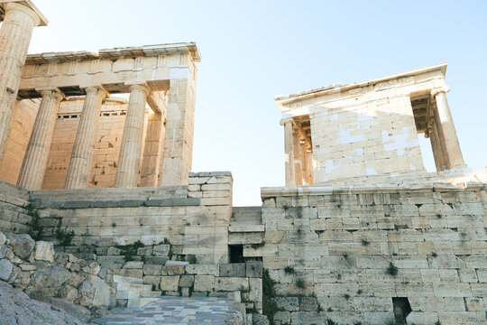 Ancient marble structures and walls of the Acropolis complex in Athens, Greece.