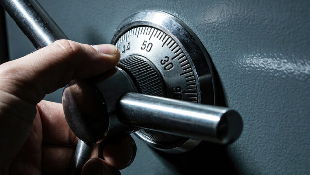 Hand turning combination lock on safe, security and finance concept