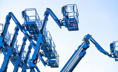 Articulated boom lift. Aerial platform lift. Telescopic boom lift against clear sky. Mobile construction crane for rent and sale. Maintenance and repair hydraulic boom lift service. Crane dealership. © Fahroni