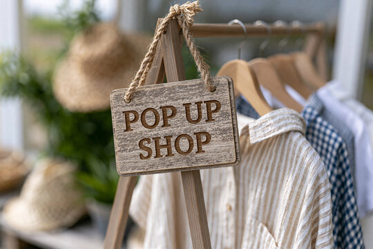 Wooden POP UP SHOP sign for a temporary clothing store