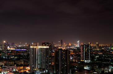 Fototapeta premium Cityscape of modern building in the night. Modern architecture office building. Skyscraper with beautiful evening sky. Business and financial center building. Apartment in the city with night light.