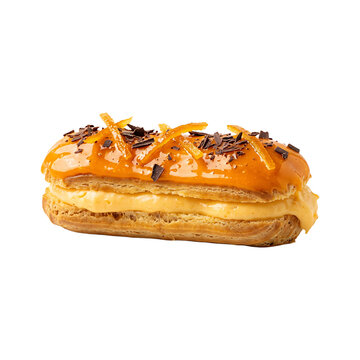 Gourmet French eclair with orange glaze, cream filling and chocolate shavings isolated on white.
