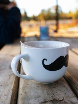 Tea time outdoors featuring a illustrated mug with tea bag tag during golden hour