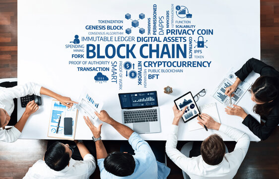 A top-down view of a business meeting discussing blockchain technology, focusing on digital assets, cryptocurrency, and the strategies for successful implementation in modern finance. Amity
