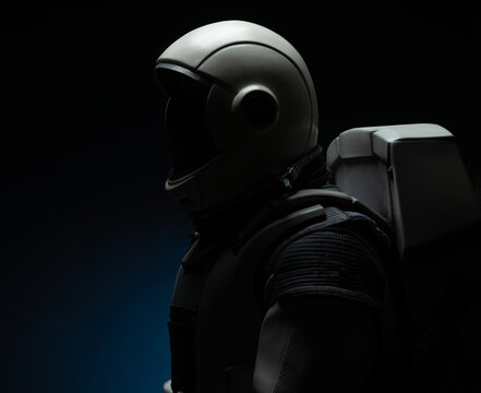 silhouette of a spacesuit on a dark background