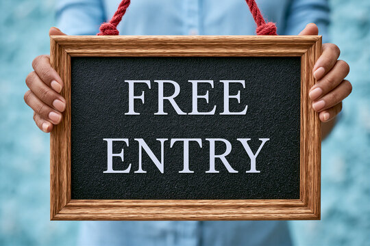 Person holding a wooden-framed FREE ENTRY sign