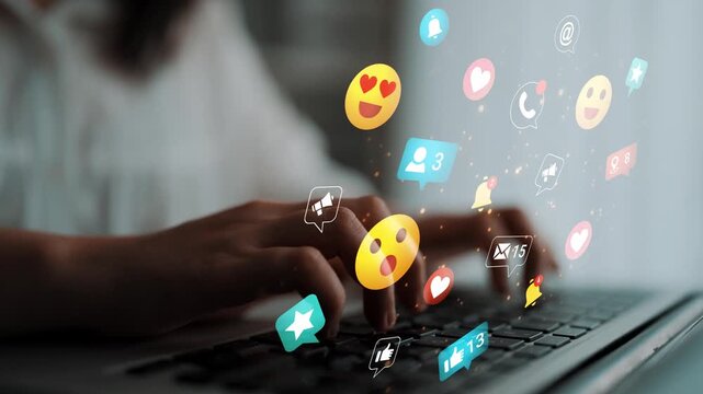 Digital Interaction with Social Media Icons and Emoticons Displayed While Typing on a Laptop Keyboard in a Bright Workspace Gluon.