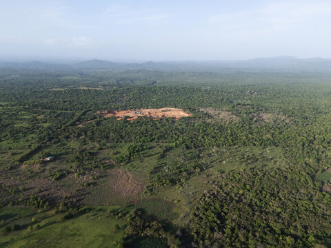 Sand quarry around green forest jungle