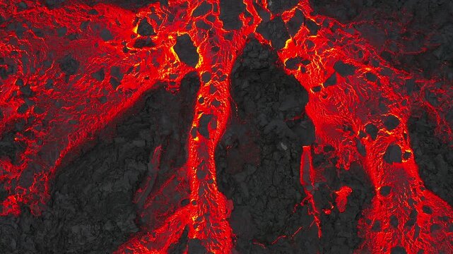 Aerial overhead view showing glowing molten lava flowing across dark