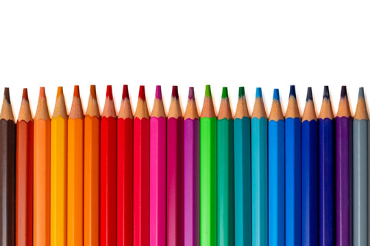 Row of vibrant colored pencils aligned horizontally at the bottom edge against a pure white background. Creativity, education, and art concept. Copy space for text.