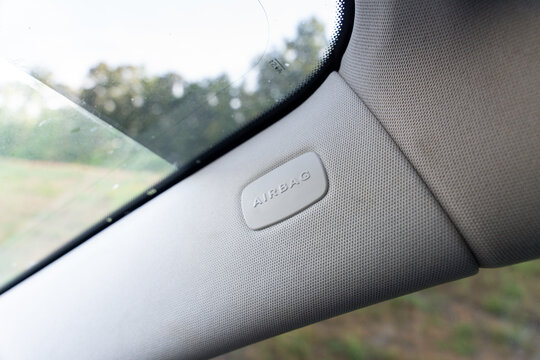Close-up of a passenger-side AIRBAG panel with textured trim near the window, highlighting automotive safety, interior materials, and modern vehicle design