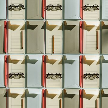 Overhead grid of blank insurance claim forms and paper sheets with eyeglasses and pencils for business and audit documentation background